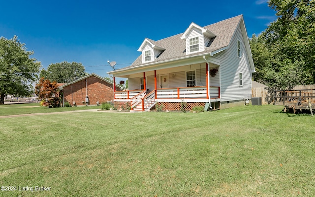 cape cod-style house with cooling unit and a front lawn