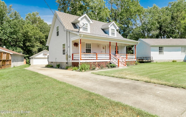 new england style home with a front yard, an outdoor structure, a garage, and covered porch