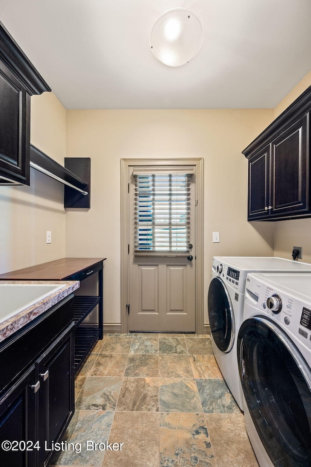 laundry area featuring washing machine and dryer and cabinets