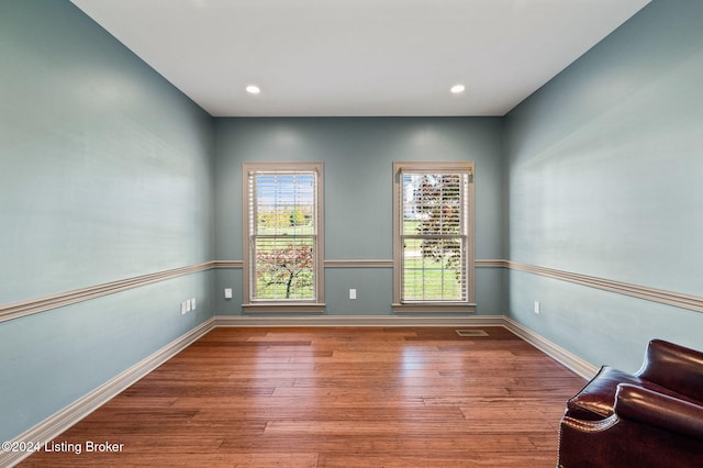 unfurnished room with hardwood / wood-style flooring