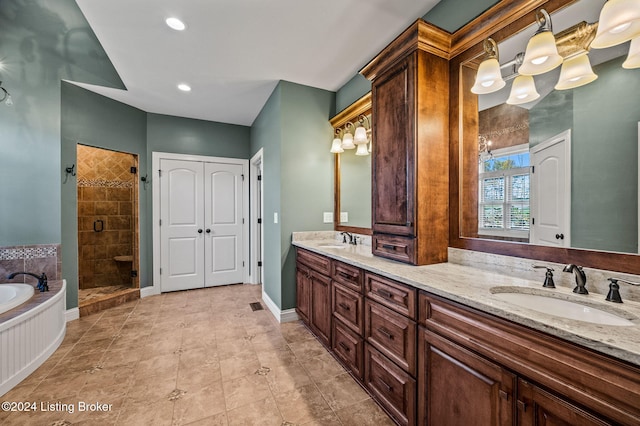 bathroom with vanity and shower with separate bathtub