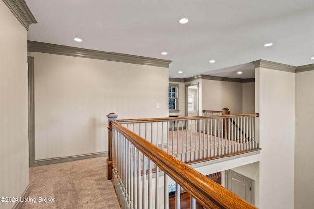 hall featuring ornamental molding and carpet floors