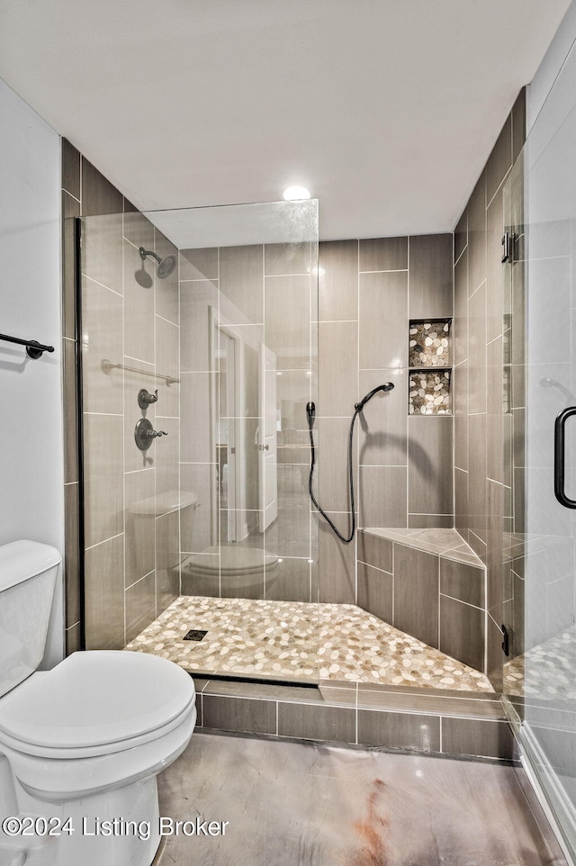 bathroom with walk in shower and toilet