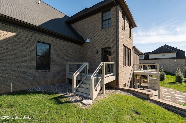 rear view of property with a patio area and a lawn