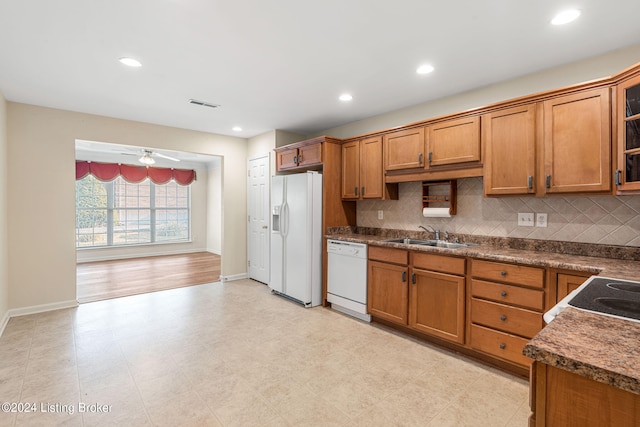 kitchen with tasteful backsplash, sink, white appliances, and ceiling fan