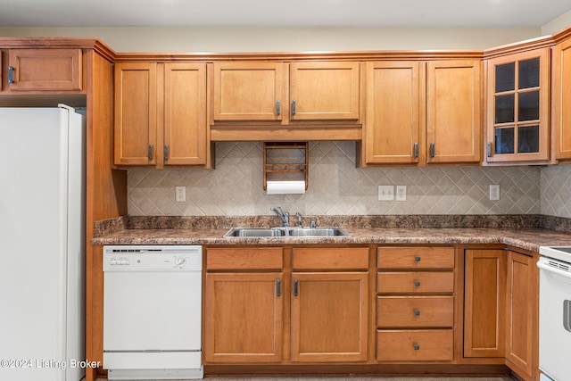 kitchen featuring tasteful backsplash, sink, and white appliances