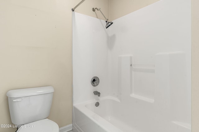 bathroom with washtub / shower combination and toilet