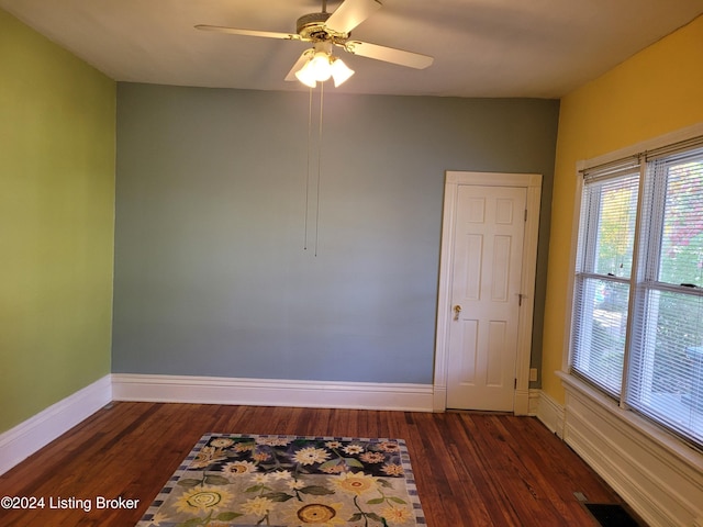 empty room featuring ceiling fan and dark hardwood / wood-style flooring