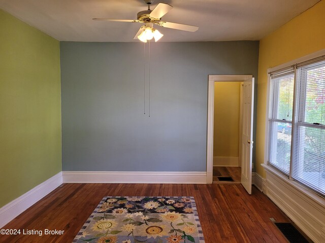 unfurnished room with ceiling fan and dark hardwood / wood-style floors