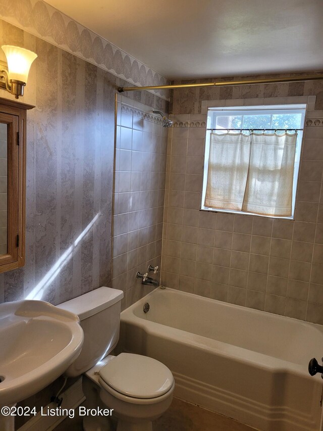 full bathroom with vanity, toilet, and tiled shower / bath combo