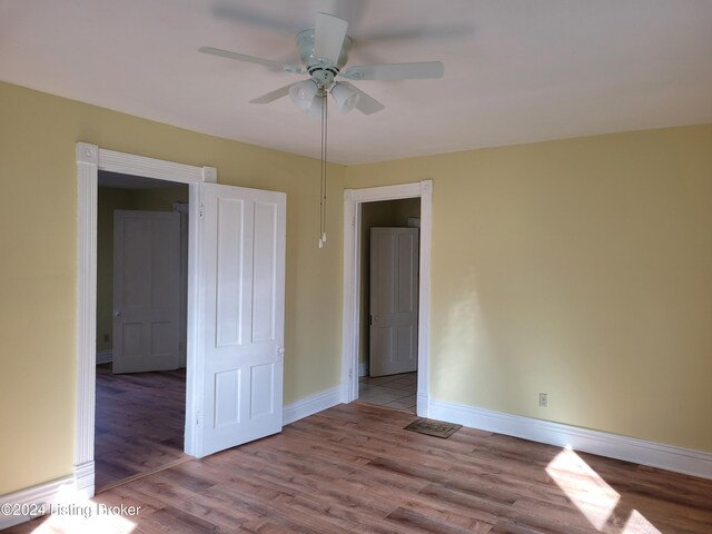 unfurnished room with light hardwood / wood-style floors and ceiling fan