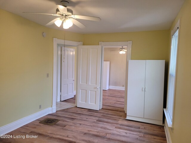 unfurnished bedroom with light hardwood / wood-style flooring and ceiling fan