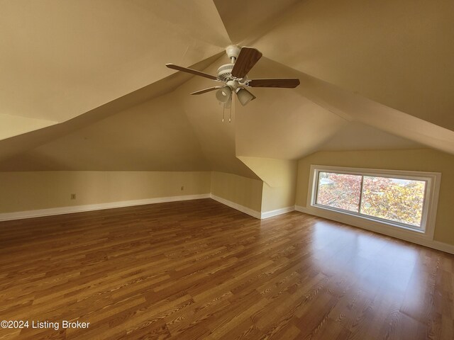 bonus room featuring lofted ceiling, dark hardwood / wood-style floors, and ceiling fan