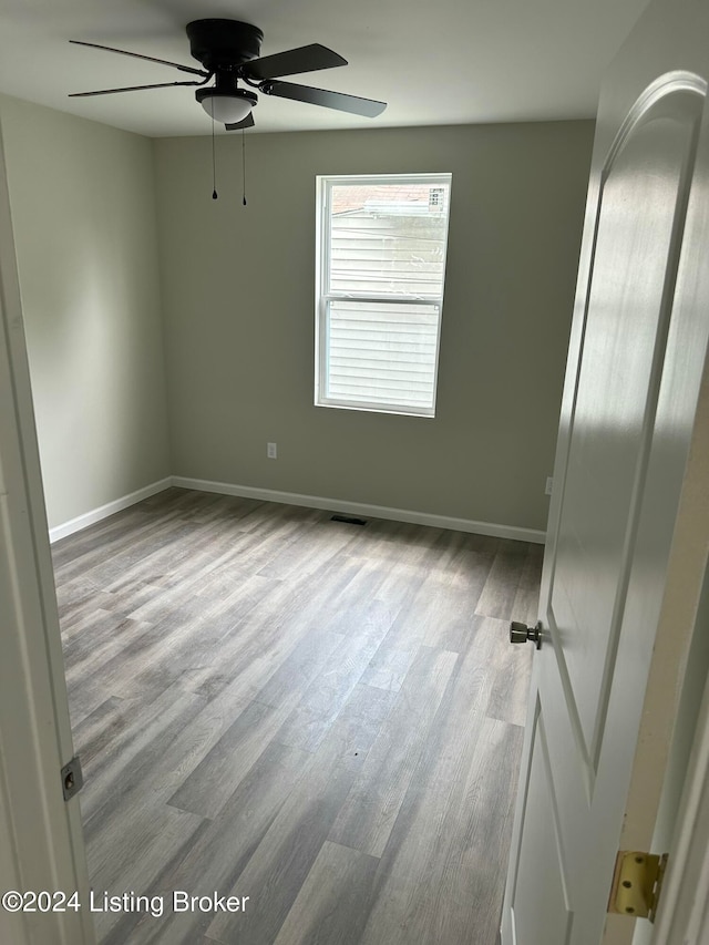 spare room featuring light hardwood / wood-style floors and ceiling fan