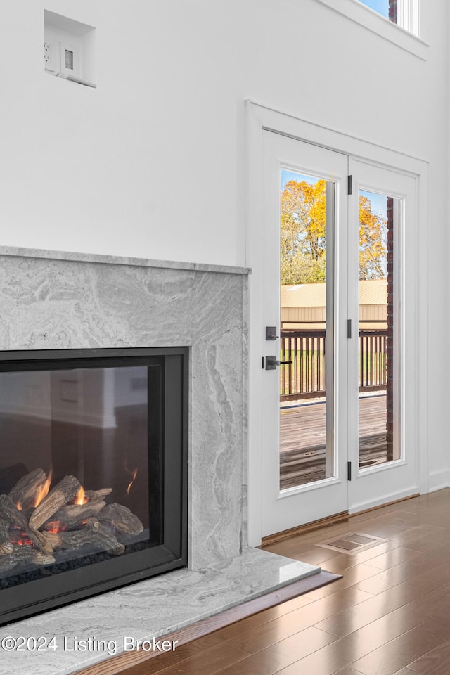 interior details with hardwood / wood-style flooring and a premium fireplace