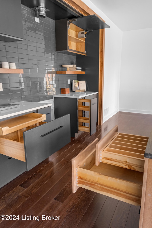 kitchen featuring backsplash and dark hardwood / wood-style flooring