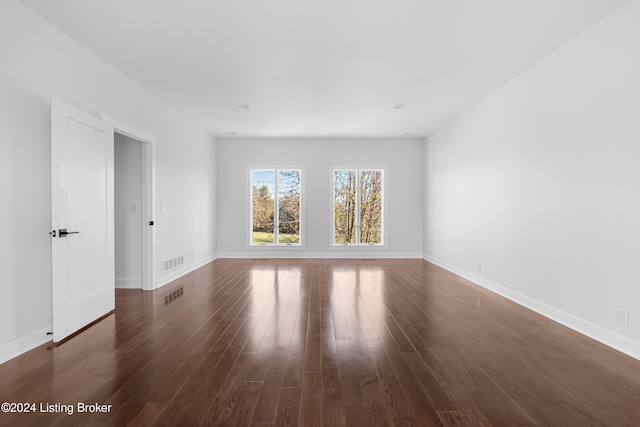 spare room with dark hardwood / wood-style flooring