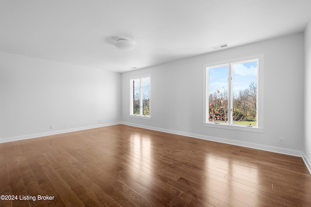 spare room with dark hardwood / wood-style flooring