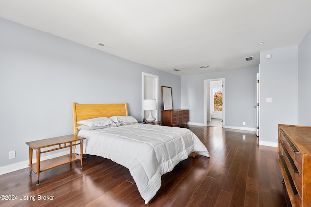 bedroom with dark wood-type flooring