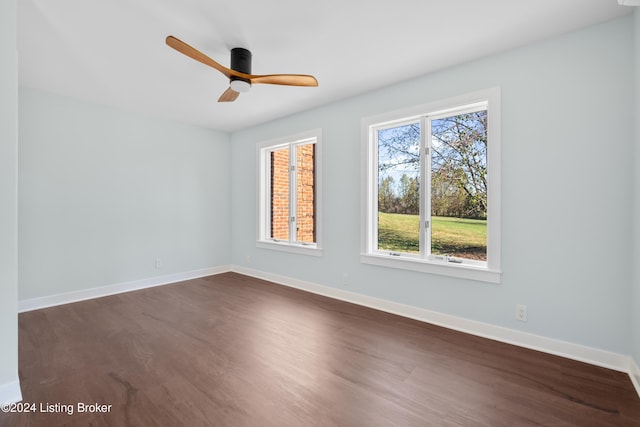 spare room with dark hardwood / wood-style floors and ceiling fan