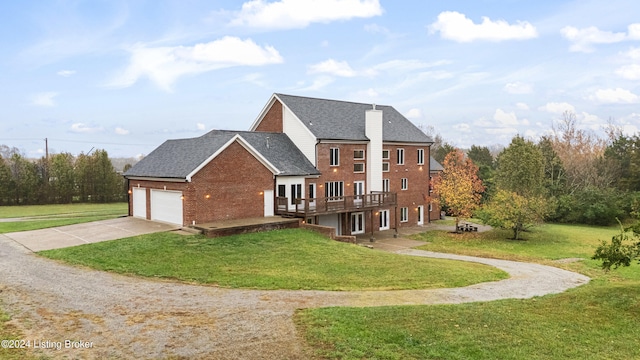 view of front of property with a garage, a front lawn, and a wooden deck