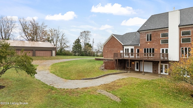 view of yard with french doors, a garage, and a deck