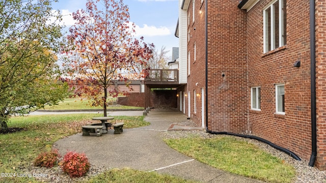 exterior space featuring a wooden deck and a patio area