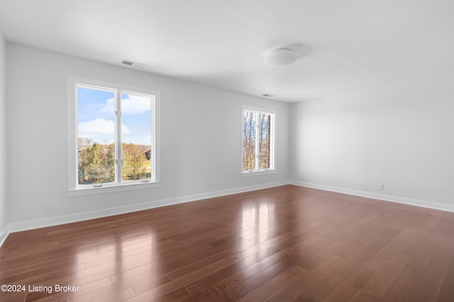 empty room with dark wood-type flooring