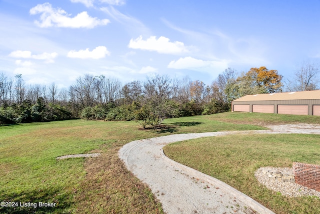 view of yard featuring a garage and an outdoor structure