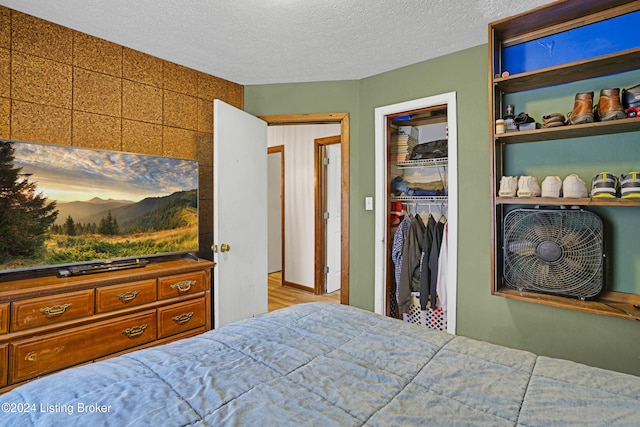 bedroom with a closet and a textured ceiling