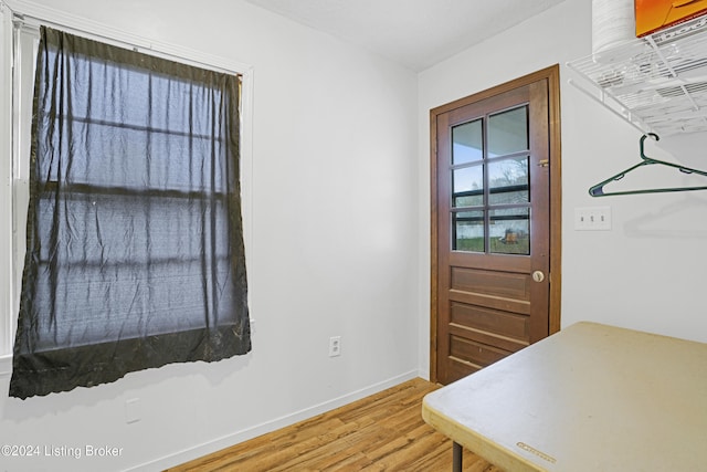 interior space featuring light wood finished floors and baseboards