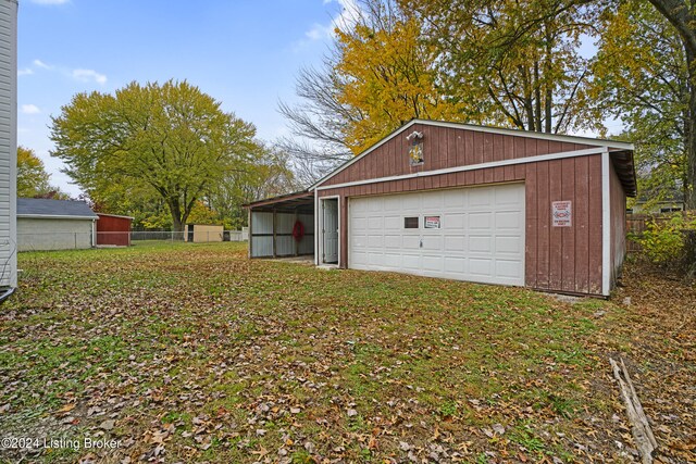 garage featuring a garage and fence