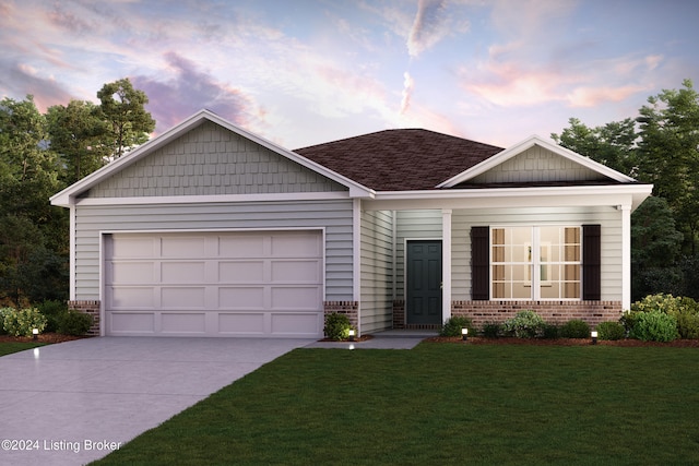 view of front facade featuring a garage and a yard