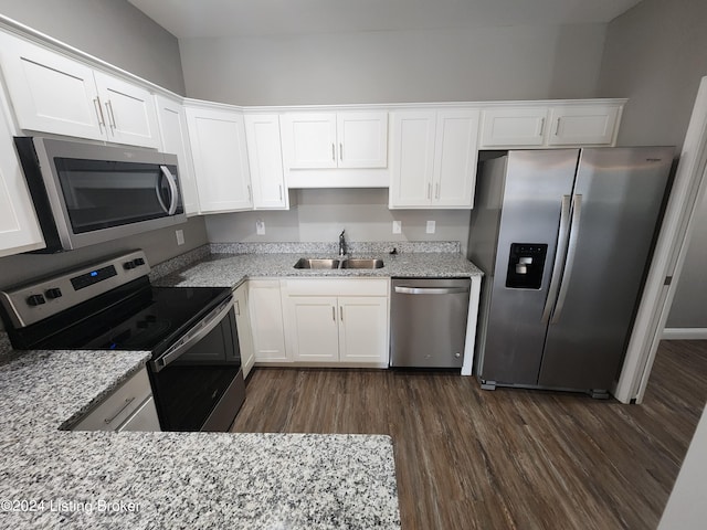 kitchen with white cabinetry, appliances with stainless steel finishes, dark wood-type flooring, and light stone counters