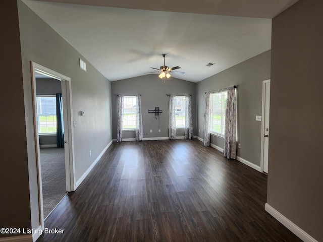 spare room featuring dark wood-type flooring, ceiling fan, and plenty of natural light