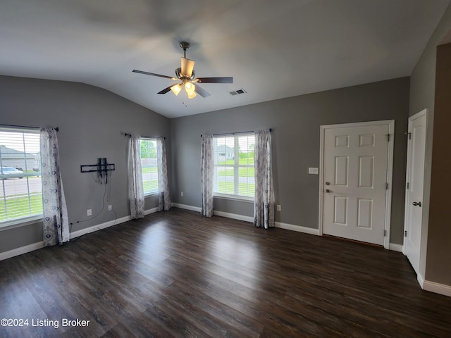 spare room with ceiling fan, vaulted ceiling, and dark hardwood / wood-style floors