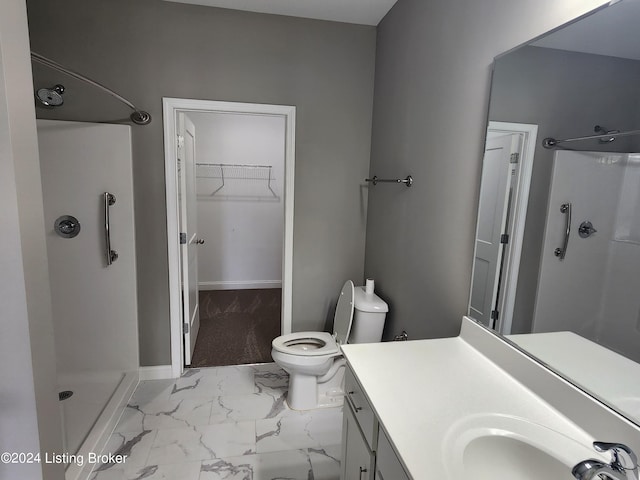 bathroom with toilet, a shower, and vanity