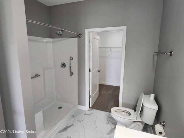 bathroom with toilet and a shower