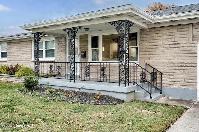 property entrance with a yard and a porch