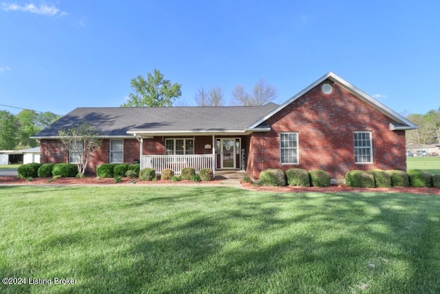 ranch-style home with a front yard and covered porch