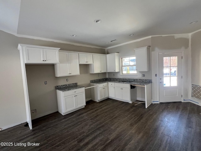 kitchen featuring dark wood-type flooring, white cabinets, dishwasher, and sink