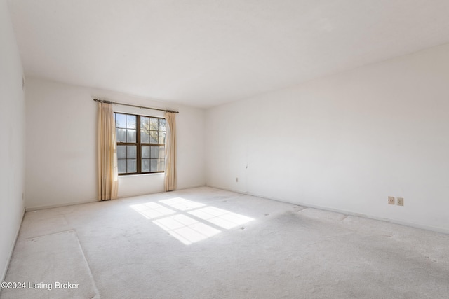 empty room featuring light colored carpet