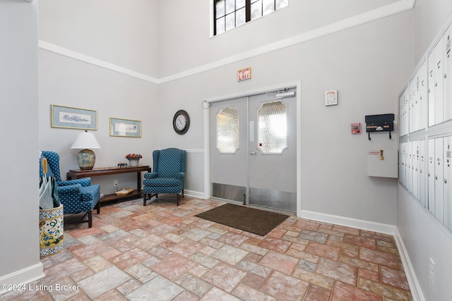 foyer featuring a high ceiling, french doors, and mail boxes