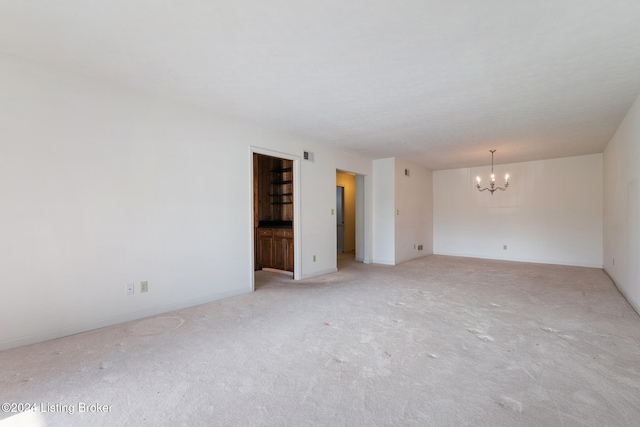 spare room with a notable chandelier