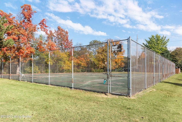 view of sport court with a yard