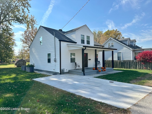 front facade with a patio area, a porch, and a front lawn