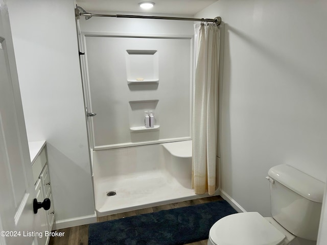 bathroom with curtained shower, vanity, toilet, and wood-type flooring