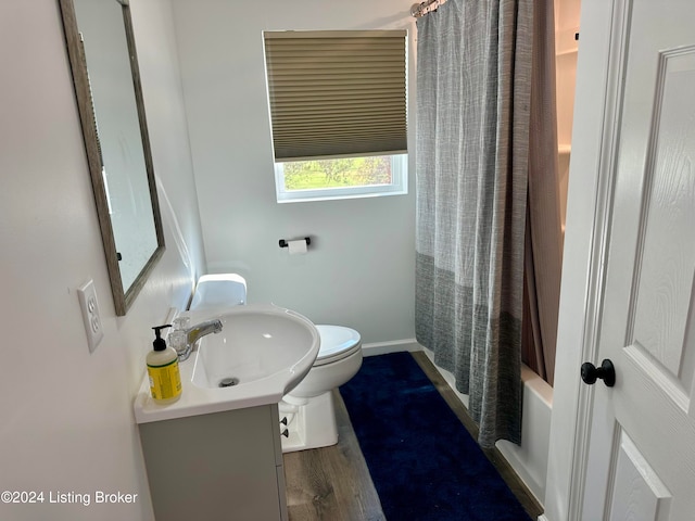 full bathroom with vanity, toilet, shower / bathtub combination with curtain, and wood-type flooring