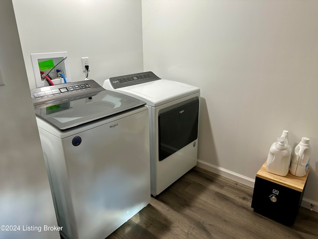 laundry area with independent washer and dryer and dark hardwood / wood-style floors