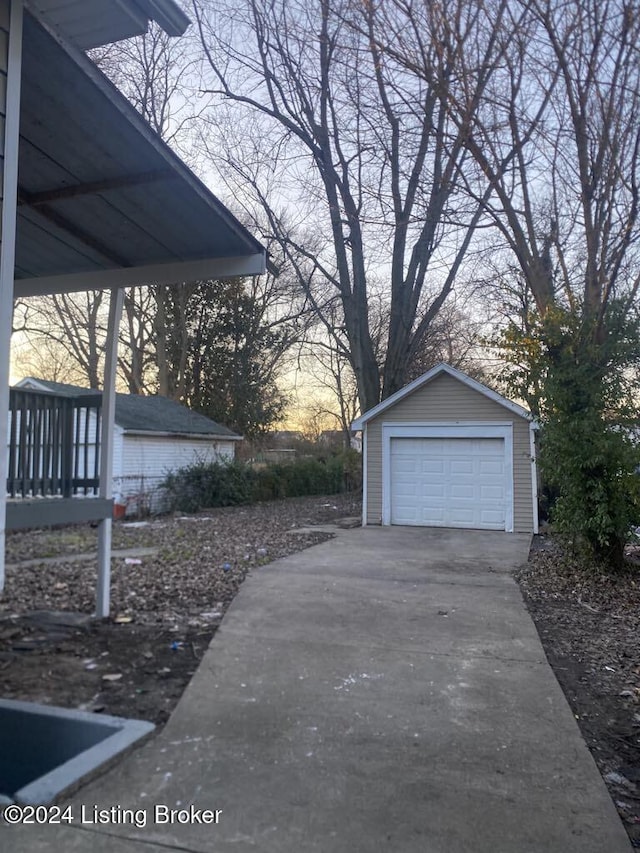 view of garage at dusk